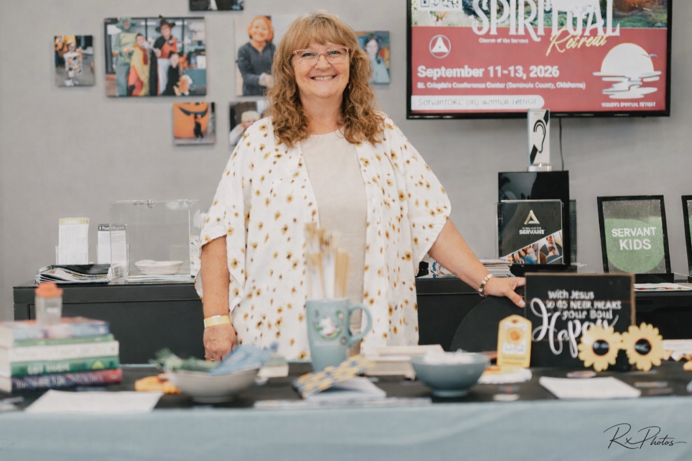 Guest smiling at an event information table