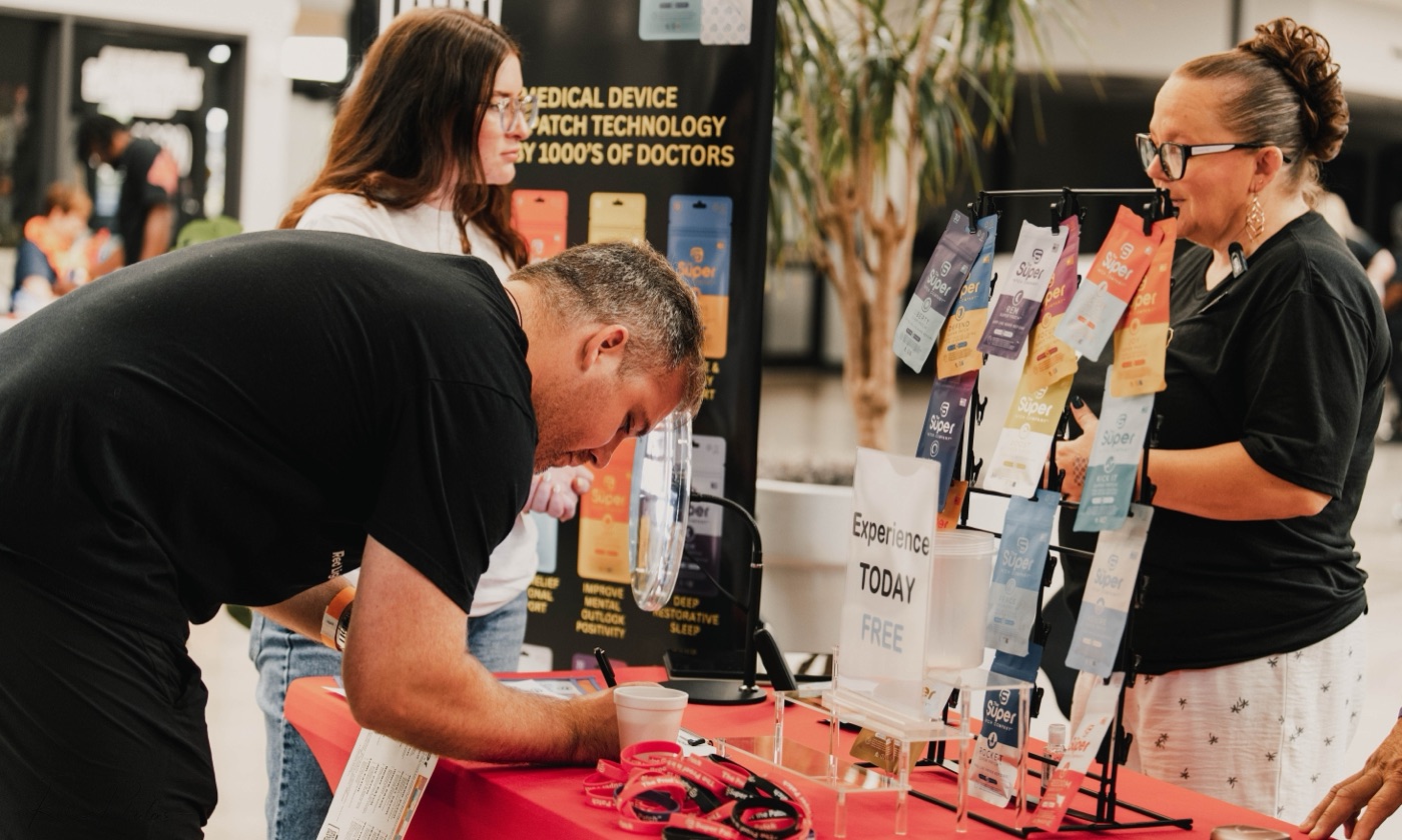 Attendees engaging at a conference vendor booth