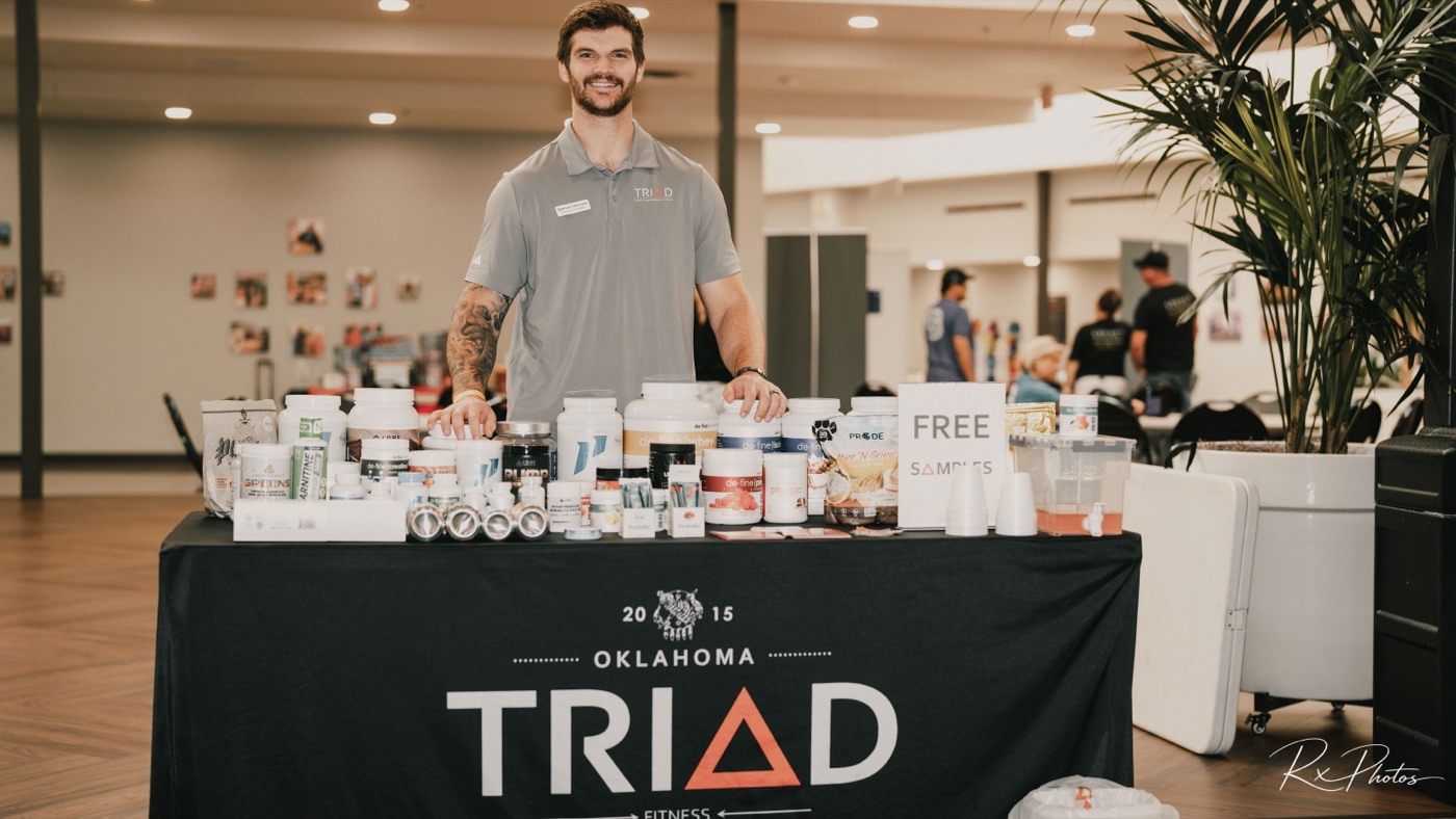 Vendor representative at a corporate supplement and wellness booth